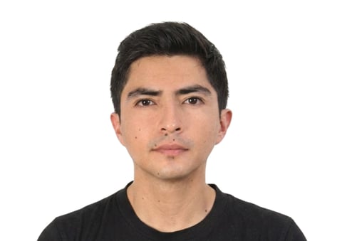 Headshot of a young man with dark hair wearing a black t-shirt against a white background